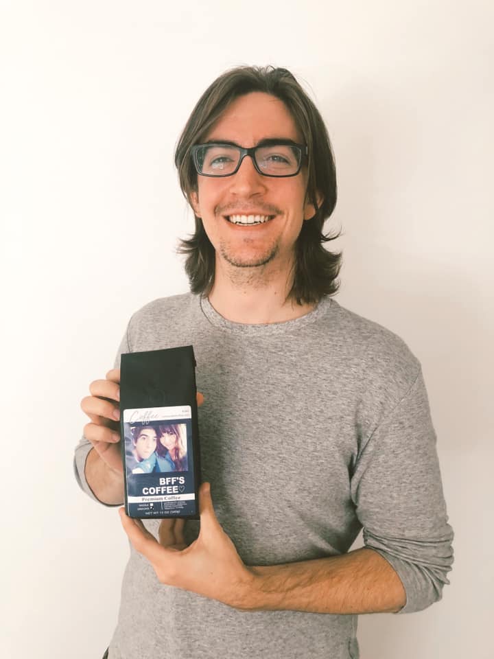 Alex holding a bag of Custom Label Coffee with a personalized photo label